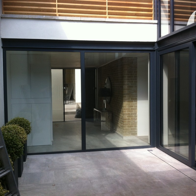 Floor-to-ceiling sliding doors opening to courtyard in West Ealing