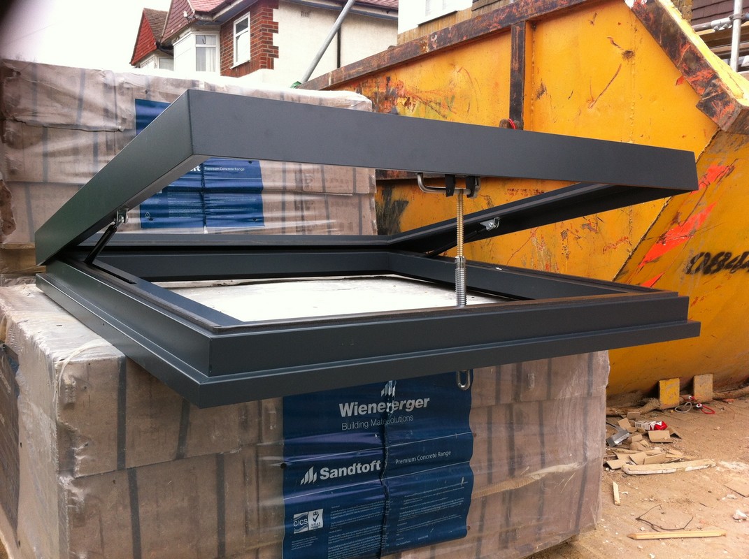 Opening flat roof skylight in anthracite grey installed in West Ealing